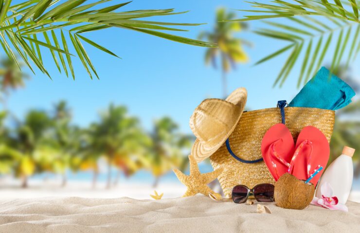 Strand met tas, slippers, zomerhoed en zonnebril